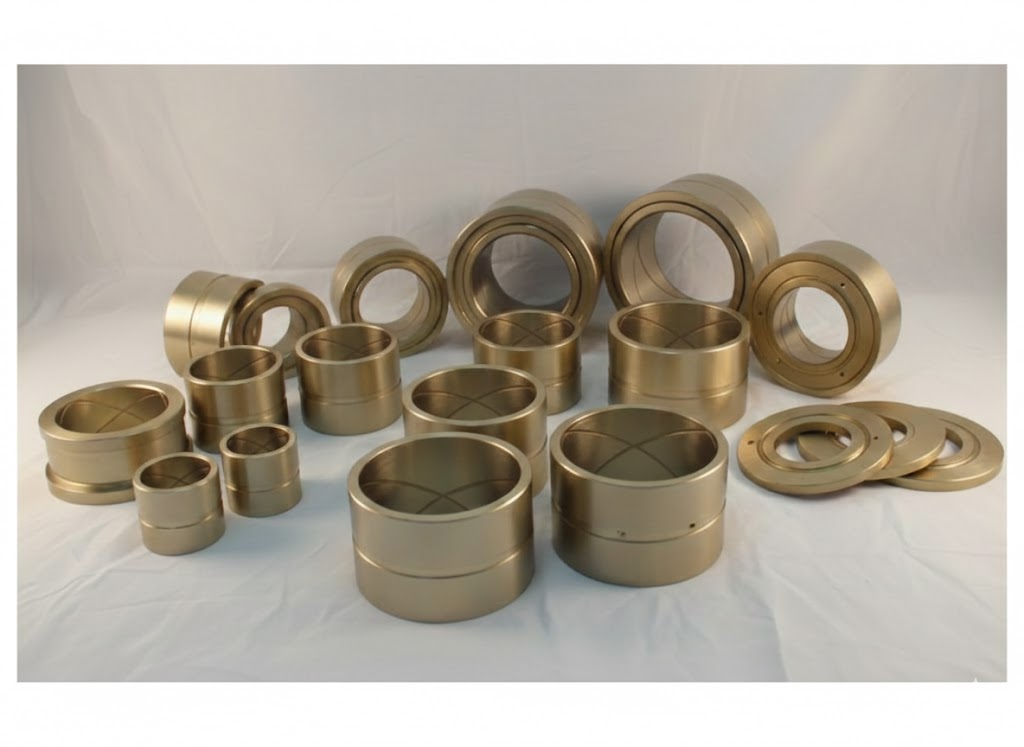 Bronze Grooved Bearings with various sizes and internal oil groove patterns on a pure white background.